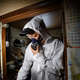 Specialist cleaner Hirotsugu Masuda enters the garbage-filled apartment of the deceased 85 year-old man. Old calendars and papers are strewn across the flat.